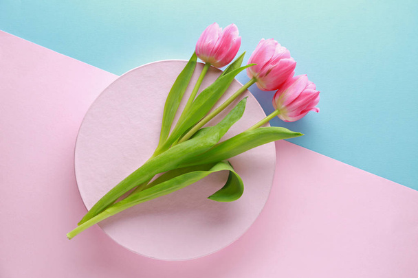 Beautiful tulips and gift box on color background - Photo, Image