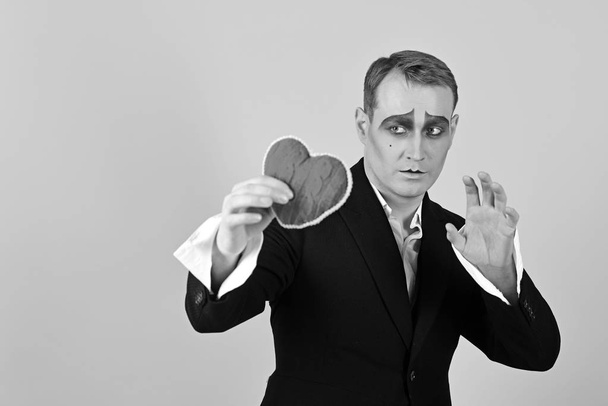 His story of boundless love. Theatre actor pantomime falling in love. Mime actor with love symbol. Mime man hold red heart for valentines day. Love confession on valentines day - Foto, Imagen