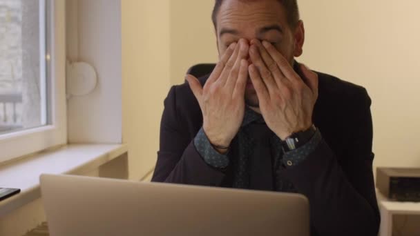 liikemies työskentelee kannettavan tietokoneen toimistossa silmät satuttaa ikkunan musta pöytä kannettavan paperit puhelin Executive Corporate
 - Materiaali, video