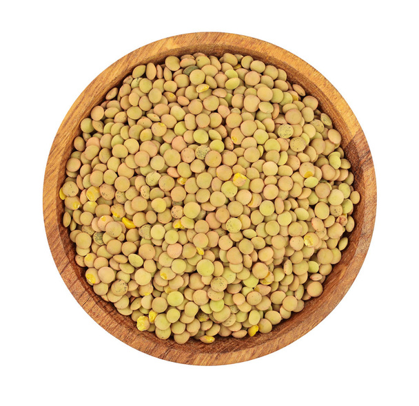 green lentil in wooden bowl isolated on white background. Top view - Photo, image