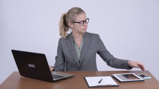 Young happy blonde businesswoman video calling at work - Footage, Video
