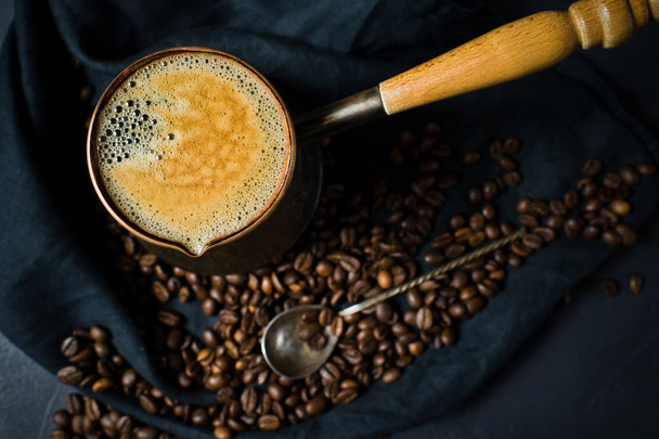 Coffee in Turk, Breakfast. Black background, top view, close up - Photo, Image