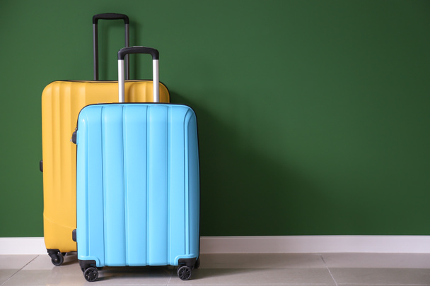 Упакованные чемоданы возле цветной стены
 - Фото, изображение