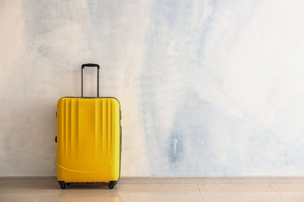 Packed suitcase near light wall - Photo, Image