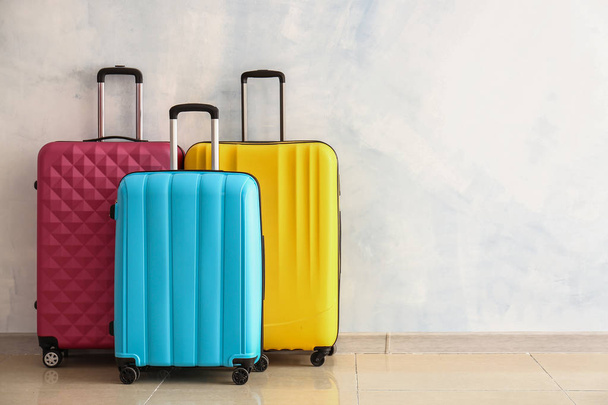 Packed suitcases near light wall - Φωτογραφία, εικόνα