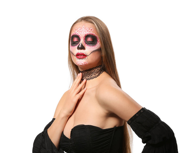 Young woman with painted skull on her face for Mexico's Day of the Dead against white background - Foto, imagen
