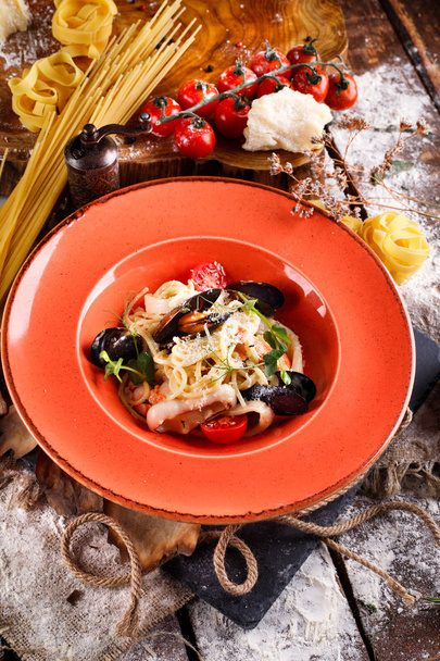 Pasta with fresh seafood, ingredients for cooking, tomatoes, pasta - Fotó, kép