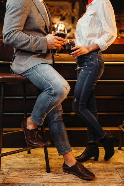Male and female person at the counter, couple in bar. Lovers leisures in pub, husband and wife relaxing together in nightclub, romantic evening - Fotó, kép