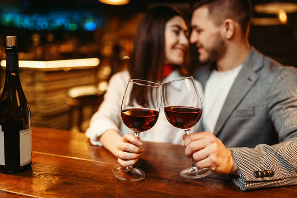Romantische avond van paar in bar, datum viering. Liefhebbers van wandelen in de pub, man en vrouw samen ontspannen in nachtclub - Foto, afbeelding