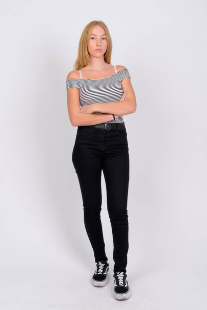 Full body shot of young beautiful blonde teenage girl with arms crossed - Photo, Image