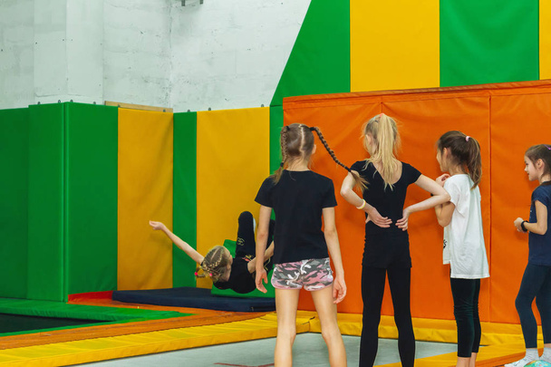 February 9, 2019 - Minsk, Belarus: Training in trampoline hall. Girls jump in trampoline hall - Фото, изображение