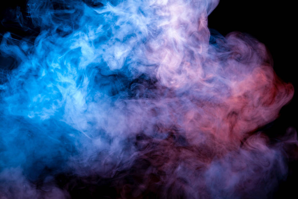 Beautiful horizontal column of smoke in the neon bright light of blue pink and orange on a black background exhaled out of the vape, mocap and print for t-shirt. - Фото, изображение