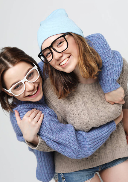 two pretty teen girlfriends smiling hugs and having fun - Foto, immagini