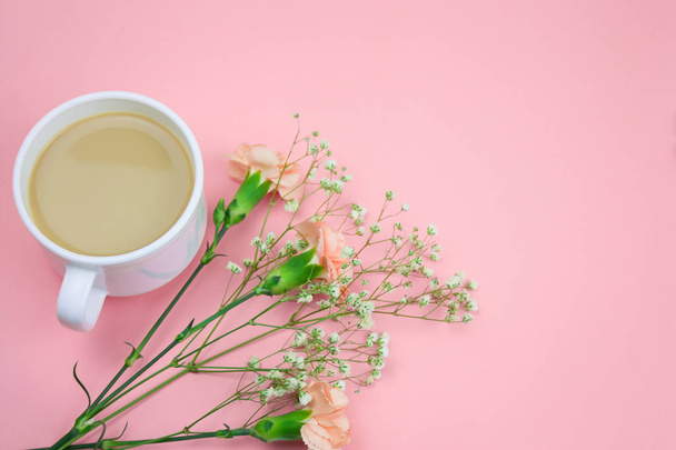 top view coffee with cream and flowers on a pastel pink background - Photo, image