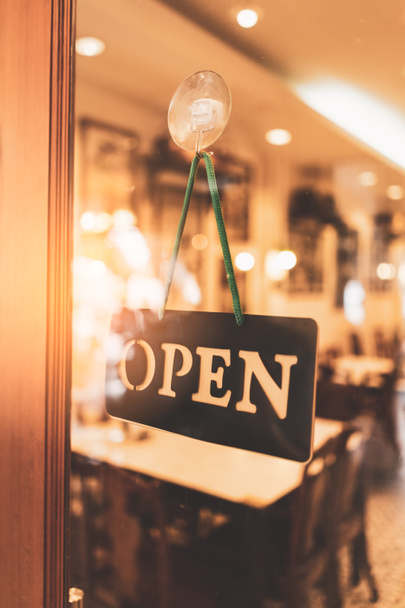 Open sign hanging front of cafe with colorful bokeh light abstract background. Business service and food concept. Vintage tone filter effect color style. - Foto, Bild