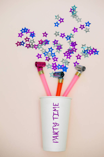 Party time. Part blowers and party poppers. Confetti in the shape of stars - Photo, Image