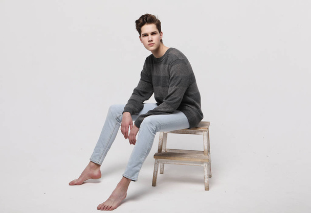 stylish fashion man model sitting on the chair  - Valokuva, kuva