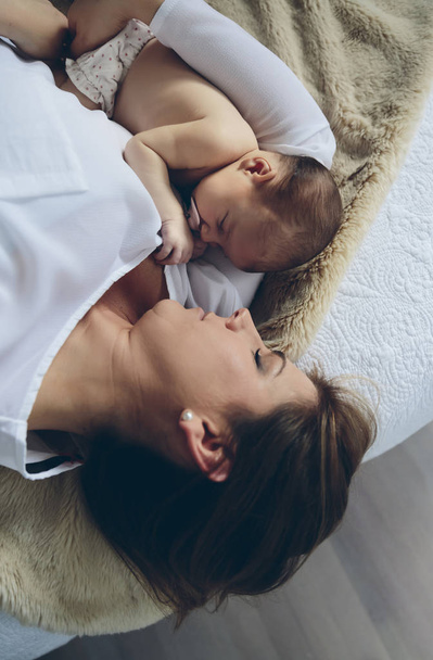 Madre che abbraccia la sua neonata
 - Foto, immagini