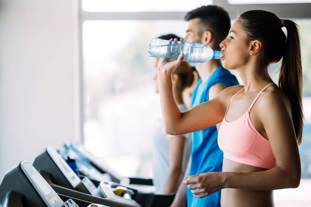 Picture of people doing cardio training on treadmill in gym - Valokuva, kuva