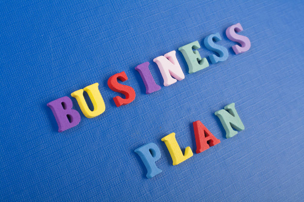 BUSINESS PLAN word on blue background composed from colorful abc alphabet block wooden letters, copy space for ad text. Learning english concept. - Foto, afbeelding
