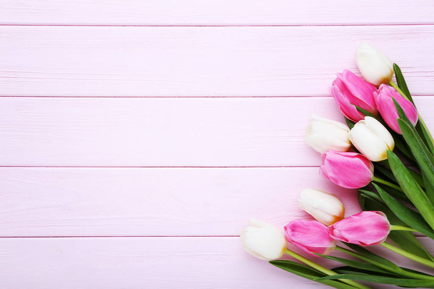 Bouquet of tulips on pink wooden table - Fotoğraf, Görsel