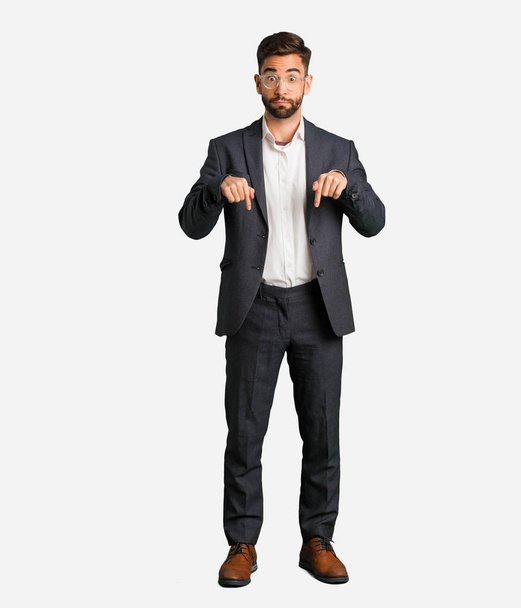Young handsome business man pointing down - Photo, Image