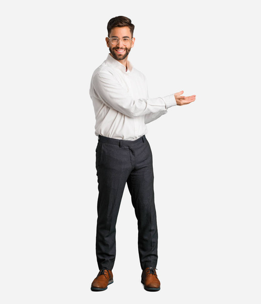Young handsome business man holding something with hands - Photo, Image