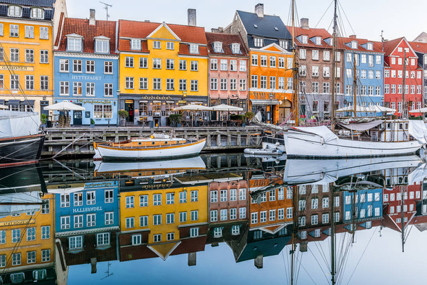 Reflections of colourful houses in the water of Nyhavn canal in  - Photo, Image