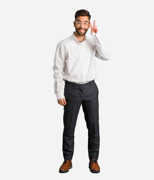 Mladý pohledný obchodní muž, zábavný a happy dělá gesto vítězství - Fotografie, Obrázek