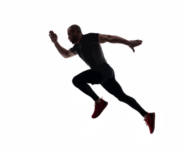 Silhouet van sport man loopt, geïsoleerde op witte achtergrond  - Foto, afbeelding
