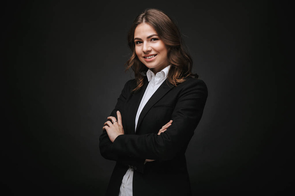 Confident young businesswoman wearing a suit standing - Фото, изображение