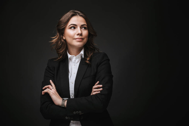 Confident young businesswoman wearing a suit standing - Fotó, kép