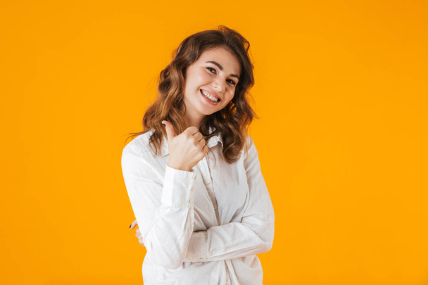 Portrait of a cheerful young woman wearing white shirt - Photo, image