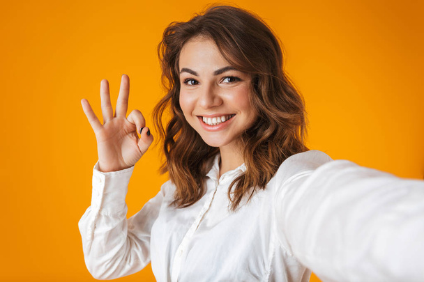 Portrait of a cheerful young woman wearing white shirt - Foto, Imagen