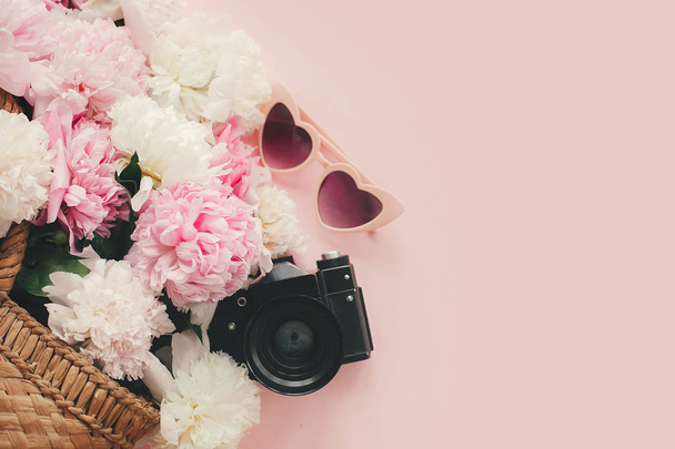 Stylish photo camera, sunglasses, straw  bag with pink and white - Фото, изображение