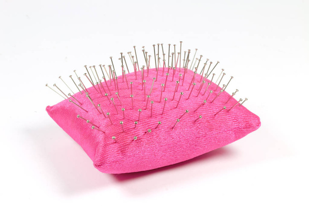 rosa Nadelkissen mit Nadeln isoliert auf weißem Hintergrund - Foto, Bild