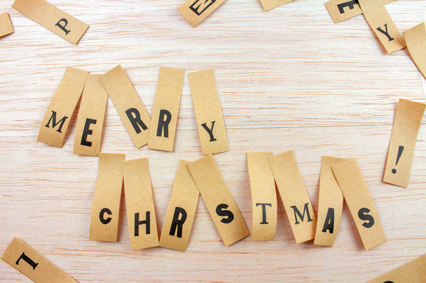 close-up shot of words merry Christmas made with stickers attached on wooden surface - Foto, immagini