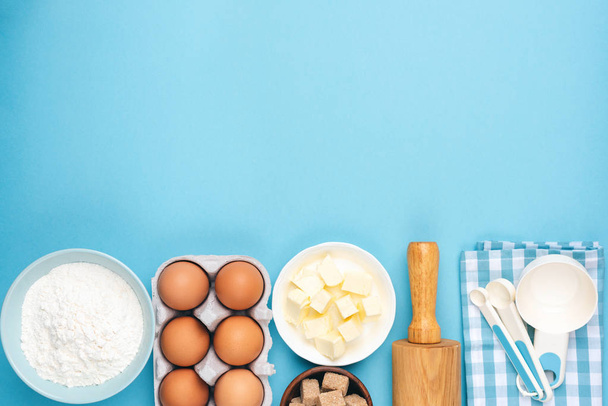 Ingredients for baking or cooking on blue background - Foto, imagen