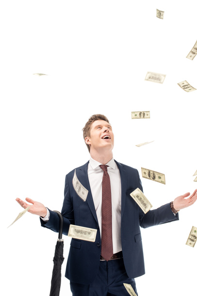 successful young businessman with falling dollars isolated on white - Фото, изображение