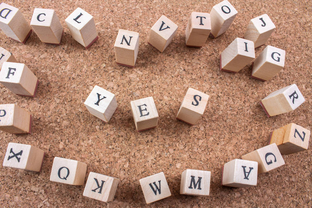 Top view of Wooden alphabet cubes on cork Background - Photo, Image