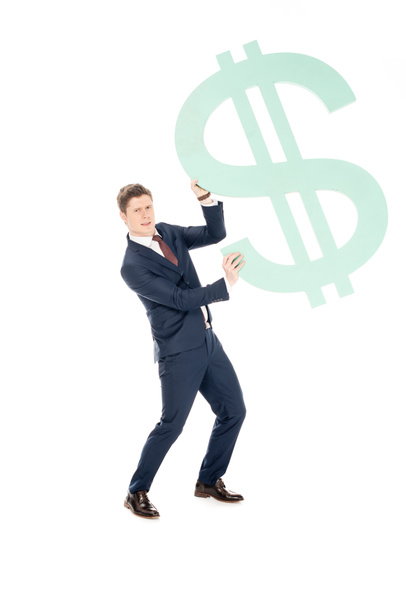 young successful businessman holding big dollar symbol isolated on white - Foto, Bild