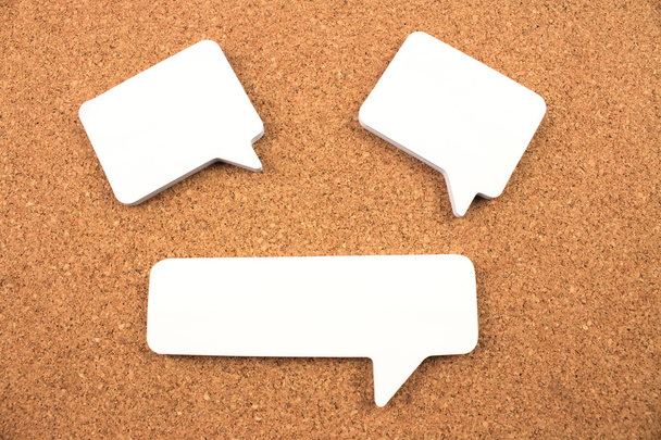 close-up shot of blank paper speech bubbles on cork background - Photo, Image