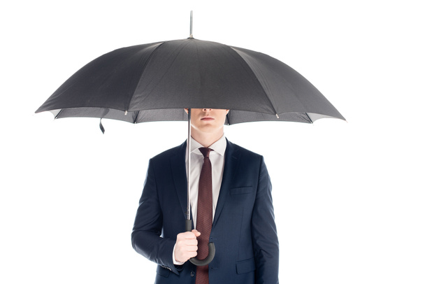 白で隔離の傘を持ってあいまいな顔とスタイリッシュなビジネスマン - 写真・画像