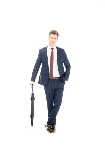 stylish businessman posing with umbrella isolated on white - Fotó, kép