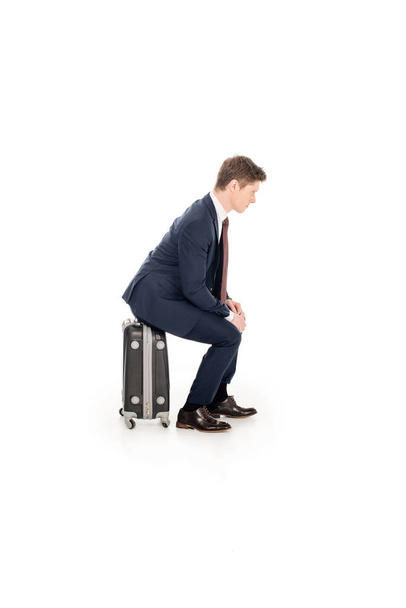 businessman sitting on baggage for business trip, isolated on white  - 写真・画像