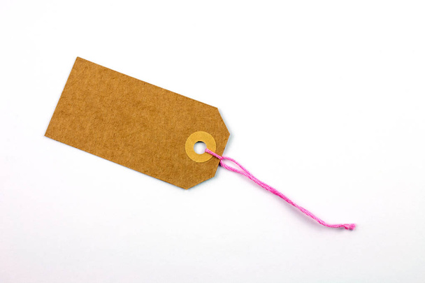 cardboard tag tied with string isolated on white - Foto, Bild