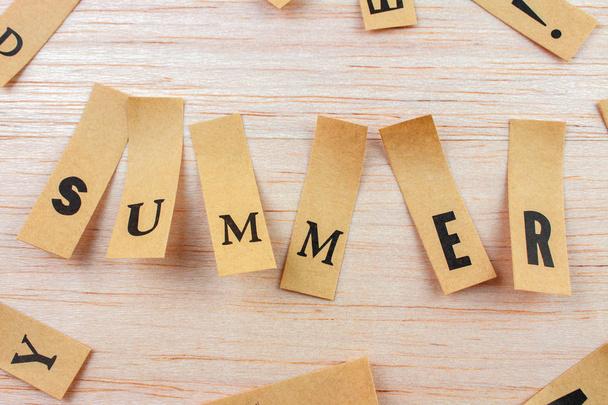 close-up shot of word summer made with stickers attached on wooden surface - Photo, Image
