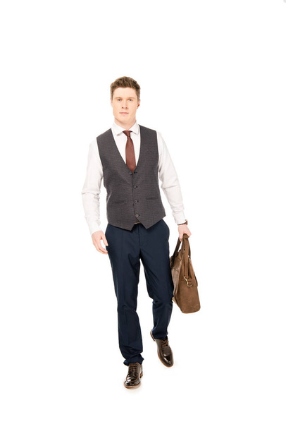 stylish young businessman walking with bag isolated on white - Foto, Imagem