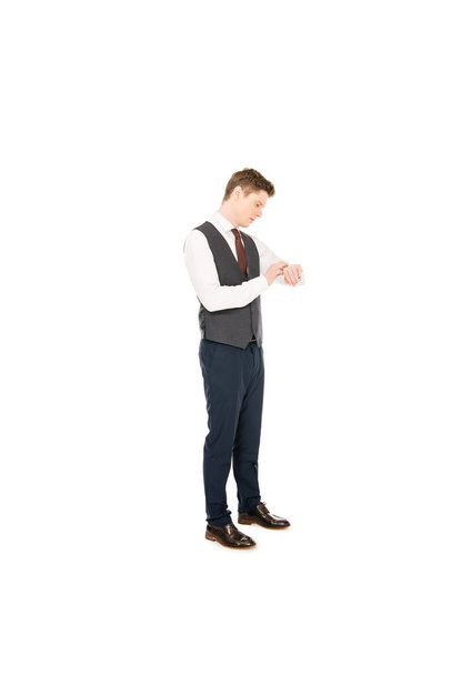 stylish businessman looking at wristwatch isolated on white - Foto, Imagem