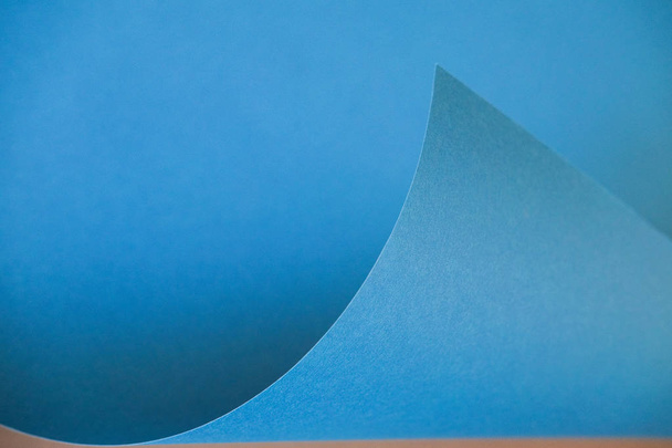 Abstraction of a design blue paper. Empty space on monochrome paper.   - Photo, image